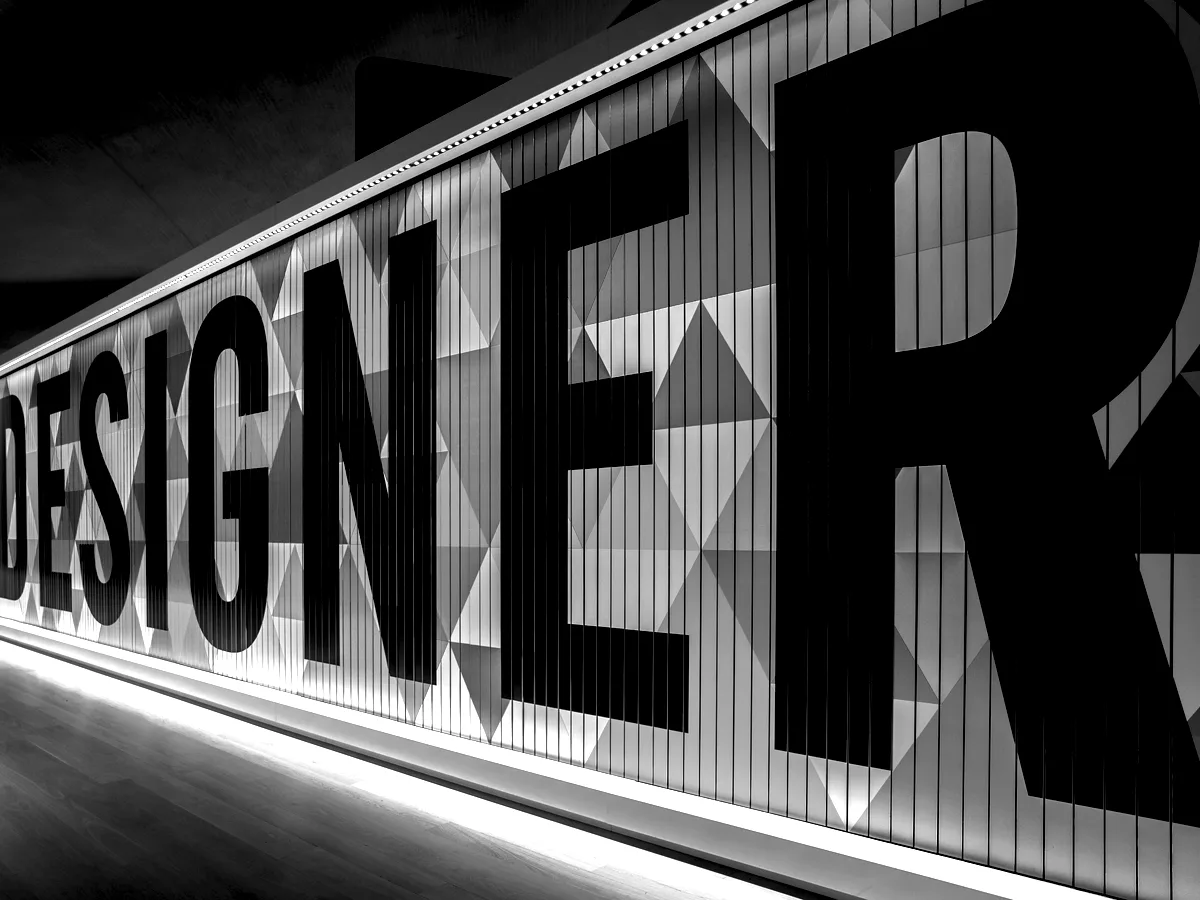 Oversized dimensional lettering mounted along an interior wall.