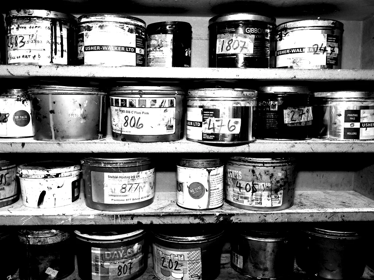 A shelf of ink tins, each hand-labelled.