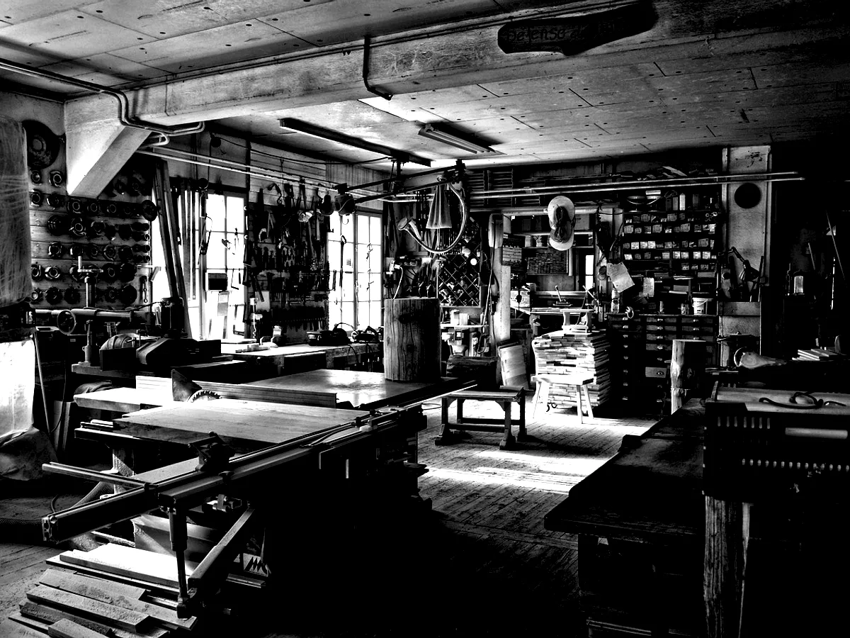 A printing workshop with presses under high windows.